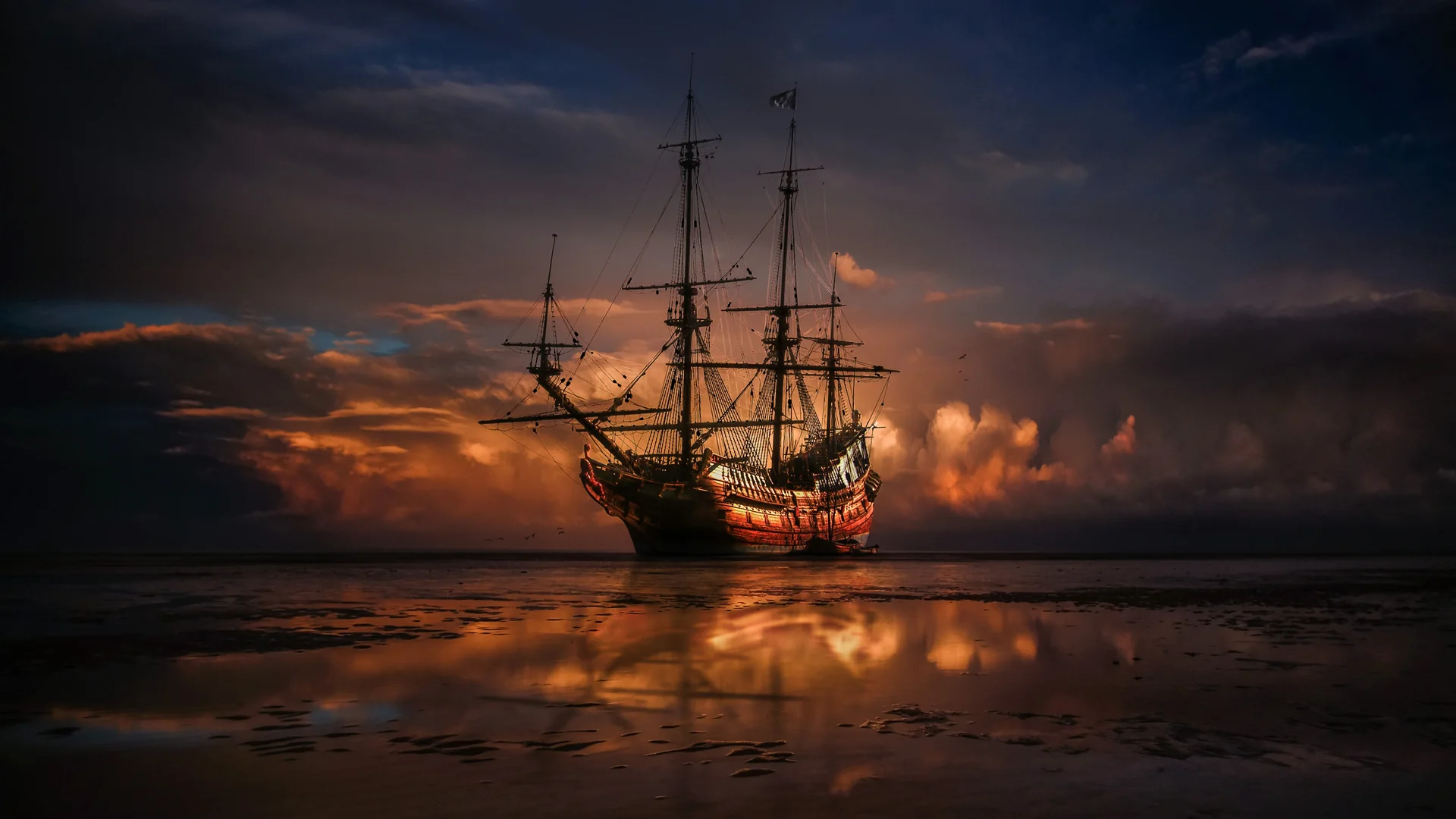 A tall-masted pirate ship under full rigging sailing into harbour — representative of the ship set staged inside the Pirates Theatre, not the venue itself